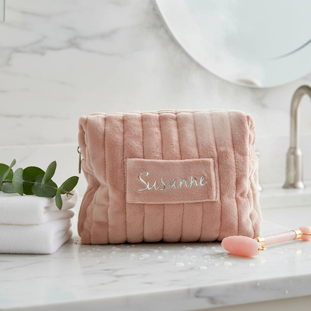 Personalized pink quilted pouch with name Susanne on marble bathroom counter