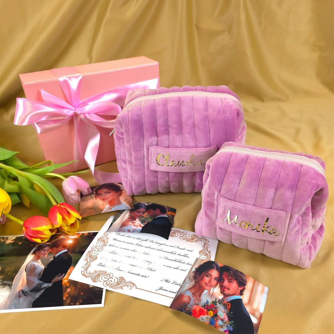 Personalized pink velvet pouches with names, pink gift box with ribbon, and flower bouquet on beige fabric